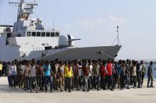 Migrants disembark from the Italian Navy vessel Cigala Fulgosi in the Sicilian harbour of Augusta, Italy, September 3, 2015. PHOTO BY REUTERS/Antonio Parrinello