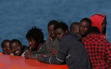 Migrants, who are part of a group intercepted aboard a makeshift boat off the coast in the Mediterranean sea, stand on a rescue boat upon arriving at a port in Malaga, southern Spain, May 19, 2016. PHOTO BY REUTERS/Jon Nazca