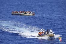 Migrants sit in a rescue boat during a rescue operation by Italian Navy vessels off the coast of Sicily in this April 11, 2016 handout picture provided by Marina Militare. PHOTO BY REUTERS/Marina Militare