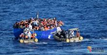 Migrants sit in their boat during a rescue operation by Italian navy ship Borsini (unseen) off the coast of Sicily, Italy, in this handout picture courtesy of the Italian Marina Militare released on July 19, 2016. PHOTO BY REUTERS/Marina Militare