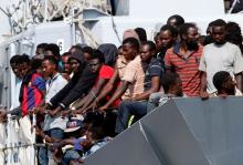 Migrants wait to disembark from the Italian Navy vessel Sfinge in the Sicilian harbour of Pozzallo, southern Italy, August 31, 2016. PHOTO BY REUTERS/Antonio Parrinello