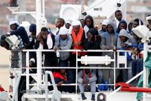 Migrants wait to disembark from a MSF (Medecins Sans Frontieres) vessel in the Sicilian harbour of Catania, Italy, November 6, 2016. PHOTO BY REUTERS/Antonio Parrinello