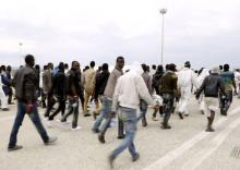 A group of migrants walk after disembarking at the Sicilian harbour of Augusta, Italy, May 31, 2015. PHOTO BY REUTERS/Antonio Parrinello