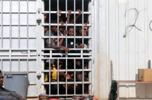 Illegal migrants, who have been detained after trying to get to Europe, look out of barred door of a detention hut at a detention camp in Gheryan, outside Tripoli, Libya, December 1, 2016. PHOTO BY REUTERS/Hani Amara