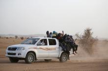 Migrants crossing the Sahara desert into Libya ride on the back of a pickup truck outside Agadez, Niger, May 9, 2016. PHOTO BY REUTERS/Joe Penney