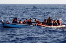 An inflatable boat from the Spanish vessel Astral operated by the NGO Proactiva collects migrants off the Libyan coast in the Mediterranean Sea, August 18, 2016. PHOTO BY REUTERS/Giorgos Moutafis