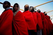 Migrants line up to be processed by authorities as they arrive at the port of Pozzallo in Sicily, Italy, January 4, 2017. PHOTO BY REUTERS/Yannis Behrakis