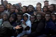 Sub-Saharan migrants are seen aboard an overcrowded raft during a rescue operation by the Spanish NGO Proactiva Open Arms in the central Mediterranean Sea, 21 miles north of the coastal Libyan city of Sabratha, February 3, 2017. PHOTO BY REUTERS/Giorgos Moutafis