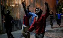 African migrants react as they arrive at the CETI, the short-stay immigrant centre, after crossing the border from Morocco to Spain's North African enclave of Ceuta, Spain, February 17, 2017. PHOTO BY REUTERS/Jesus Moron