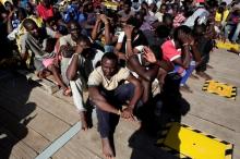 Migrants wait to disembark from the rescue vessel Responder, a rescue boat run by the Malta-based NGO Migrant Offshore Aid Station (MOAS) and the Italian Red Cross (CRI), in the Italian harbour of Vibo Marina, Italy, October 22, 2016. PHOTO BY REUTERS/Yara Nardi