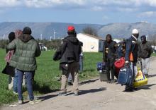 Migrants carry their belongings after a fire broke out at makeshift camp housing hundreds of migrants in the countryside near the village of Rignano Garganico, southern Italy, March 3, 2017. PHOTO BY REUTERS/Stringer