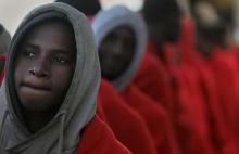 Migrants line-up to be processed by authorities before disembarking from the former fishing trawler Golfo Azzurro as they arrive at the port of Pozzallo in Sicily, January 4, 2017. PHOTO BY REUTERS/Yannis Behrakis