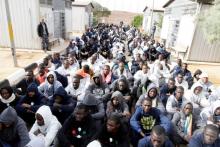 Illegal migrants, who have been detained after trying to get to Europe, sit in row on the ground of a detention camp in Gheryan, outside Tripoli, Libya, December 1, 2016. PHOTO BY REUTERS/Hani Amara