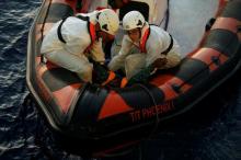 An unconscious migrant is brought from one of several boats to the Malta-based NGO Migrant Offshore Aid Station (MOAS) ship Phoenix in the central Mediterranean in international waters off the coast of Sabratha in Libya. PHOTO BY REUTERS/Darrin Zammit Lupi