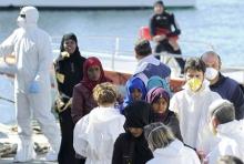 Migrants are helped as they disembark from a Coast Guard boat in the Sicilian harbour of Palermo, April 18, 2015. PHOTO BY REUTERS/Guglielmo Mangiapane