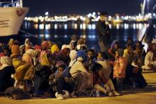 Migrants rest after disembarking from the expedition vessel Phoenix in the Sicilian harbour of Augusta, Italy, June 7, 2015. PHOTO BY REUTERS/Antonio Parrinello