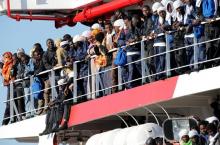 Migrants wait to disembark from "Vos Prudence" Offshore Tug Supply ship as they arrive at the harbour in Naples, Italy, May 28, 2017. PHOTO BY REUTERS/Ciro De Luca