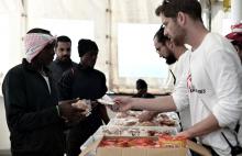 Migrants receive food on the deck of MV Aquarius, a search and rescue ship run in partnership between SOS Mediterranee and Medecins Sans Frontieres on their way to Spain, June 15, 2018. PHOTO BY REUTERS/Karpov/SOS Mediterranee