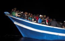 Migrants are seen onboard a drifting overcrowded wooden boat, during a rescue operation by the Spanish NGO Proactiva Open Arms, north of the Libyan city of Sabratha in the central Mediterranean Sea, March 29, 2017. PHOTO BY REUTERS/Yannis Behrakis