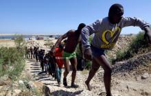 Migrants walk after they were rescued by Libyan coastguard at the coast of Gharaboli, east of Tripoli, Libya, July 8, 2017. PHOTO BY REUTERS/Ismail Zitouny