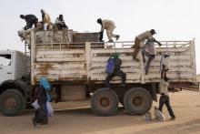 Nigeriens, who are travelling north towards Libya, board a truck in Agadez March 17, 2014. PHOTO BY REUTERS/Joe Penney