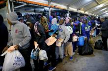 Migrants wait at Mitiga airport before their voluntary return to their countries, east of Tripoli, Libya, December 5, 2017. PHOTO BY REUTERS/Ismail Zitouny