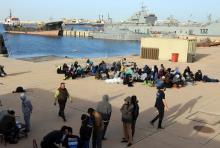 Migrants sit at a naval base after they were brought back by Libyan coast guards in Tripoli, Libya, January 7, 2018. PHOTO BY REUTERS/Hani Amara