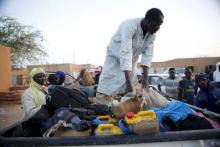 A man arranges the belongings of migrants into the back of a truck at a local transit centre in the desert town of Agadez, Niger, May 25, 2015. PHOTO BY REUTERS/Akintunde Akinleye