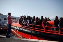 Migrants, part of a group intercepted aboard dinghies off the coast in the Mediterranean Sea, stand on a rescue boat upon arrival at the port of Motril, southern Spain, June 25, 2018. PHOTO BY REUTERS/Jon Nazca