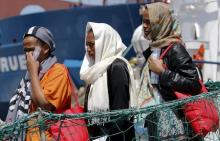 Migrants disembark from the Panamanian ship Dignity 1 in the Sicilian harbour of Pozzallo, Italy, June 23, 2015. PHOTO BY REUTERS/Antonio Parrinello