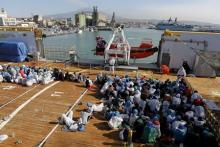 Migrants wait to disembark from the Norwegian vessel Siem Pilot at Catania's harbour, Italy, June 30, 2015. PHOTO BY REUTERS/Antonio ParrinelloBy Idrees Ali