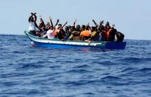 Migrants on a wooden boat react as they wait to be rescued by SOS Mediterranee organisation and Doctors Without Borders during a search and rescue (SAR) operation with the MV Aquarius rescue ship in the Mediterranean Sea, off the Libyan Coast, August 10, 2018. PHOTO BY REUTERS/Guglielmo Mangiapane