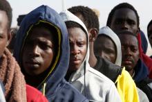 Gambian migrants deported from Libya stand in line as they wait for registration at the airport in Banjul, Gambia, April 4, 2017. PHOTO BY REUTERS/Luc Gnago