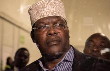 Miguna Miguna, a lawyer of dual Kenyan and Canadian citizenship, is seen through the glass door at the Jomo Kenyatta airport after he was detained by police in Nairobi, Kenya March 26, 2018, during an attempt to force him onto a plane to Canada. PHOTO BY REUTERS/Stephen Mdunga