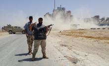 Members of forces loyal to Libya's eastern government stand near to the Libyan cement factory after the army took control of the factory following clashes with the Shura Council of Libyan Revolutionaries, an alliance of former anti-Gaddafi rebels who have joined forces with Islamist group Ansar al-Sharia, in Benghazi, Libya April 18, 2016. PHOTO BY REUTERS/Stringer