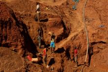 Illegal artisanal gold miners work at an open mine after occupying parts of Smithfield farm,. PHOTO BY REUTERS/Philimon Bulawayo