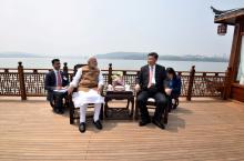 India's Prime Minister Narendra Modi speaks with Chinese President Xi Jinping as they take a boat ride on the East Lake in Wuhan, China, April 28, 2018. PHOTO BY REUTERS/India's Press Information Bureau