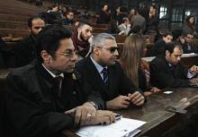 Al Jazeera journalist Mohamed Fahmy (2nd L) and his lawyer are seen inside a court before a hearing in his trial in Cairo, February 23, 2015. PHOTO BY REUTERS/Asmaa Waguih