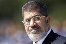 Egypt's ousted President Mohamed Mursi reviews the troops in an official ceremony before a meeting with Brazil's President Dilma Rousseff at the Planalto Palace in Brasilia