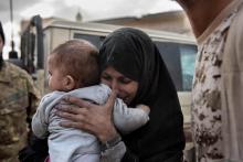 A woman and a child, allegedly Islamic State family members, are seen after fighters of the Libyan forces affiliated to the Tripoli government took them out of the fighting area in Al Jiza neighborhood. PHOTO BY REUTERS/Alessio Romenzi/Courtesy of World Press Photo Foundation