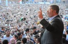 Egypt's Former President Mohamed Mursi speaks to supporters in front of the presidential palace in Cairo November 23, 2012 file photo