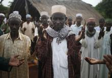 Muslim men from the Puel tribe pray in a village outside Bambari