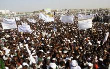 National Congress Party (NCP) supporters wave as Sudanese President and NCP presidential candidate Omar Hassan al-Bashir addresses the crowed during his campaign ahead of the 2015 presidential elections in Madani, the capital of Jazeera State, February 26, 2015. PHOTO BY REUTERS/ Stringer