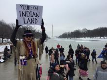 A participant holds a placard during the Indigenous Peoples March at the Lincoln Memorial in Washington, D.C., on Jan. 18, 2019. PHOTO BY Thomson Reuters Foundation/Carey L. Biron