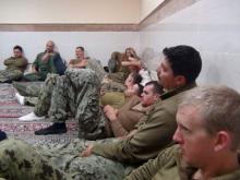 An undated picture released by Iran's Revolutionary Guards website shows American sailors sitting in an unknown place in Iran. PHOTO BY REUTERS/sepahnews.ir