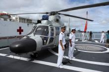 Members of the Chinese People Liberation Army Navy stand by a helicopter on the PLA(N) ship Haikou as it sits docked at Joint Base Pearl Harbor Hickam in Honolulu, Hawaii, July 5, 2014. PHOTO BY REUTERS/Hugh Gentry