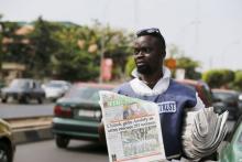 A man sells newspapers, featuring a front page article about Nigerian soldiers rescuing a group of women, in Abuja, Nigeria, April 29, 2015. PHOTO BY REUTERS/Afolabi Sotunde