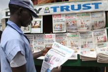 A man looks at a newspaper headline in Abuja, Nigeria, May 20, 2016. PHOTO BY REUTERS/Afolabi Sotunde