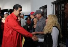 Venezuelan President Nicolas Maduro shakes hands with an electoral official while casting his vote at a polling station during the Constituent Assembly election in Caracas, Venezuela, July 30, 2017. PHOTO BY REUTERS/Miraflores Palace
