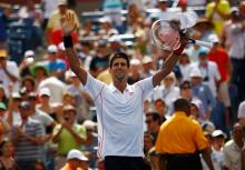 Novak Djokovic of Serbia waves after defeating Benjamin Becker of Germany at the U.S. Open